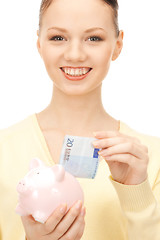 Image showing lovely woman with piggy bank 
