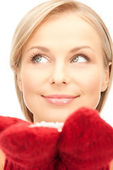 Image showing beautiful woman in red mittens with snow