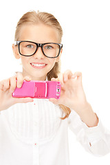 Image showing happy girl taking picture with cell phone