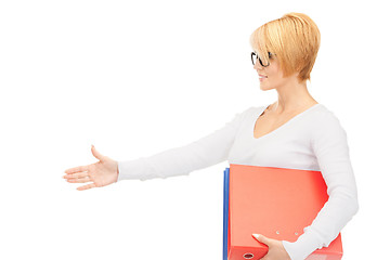 Image showing businesswoman with folders ready for handshake