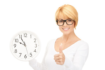 Image showing woman holding big clock