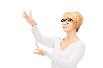 Image showing businesswoman working with something imaginary 