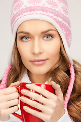 Image showing beautiful woman with red mug