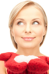 Image showing beautiful woman in red mittens with snow