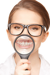 Image showing woman with magnifying glass showing teeth