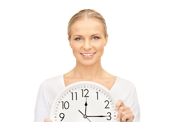 Image showing woman holding big clock