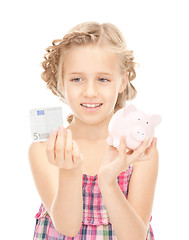 Image showing little girl with piggy bank and money