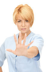 Image showing attractive female doctor showing stop gesture