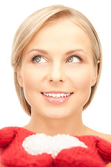 Image showing beautiful woman in red mittens with snow