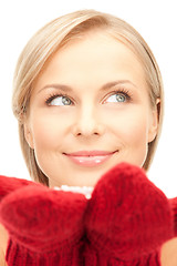 Image showing beautiful woman in red mittens with snow