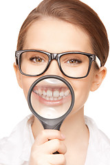 Image showing woman with magnifying glass showing teeth