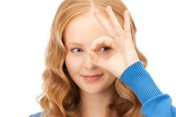 Image showing lovely woman looking through hole from fingers