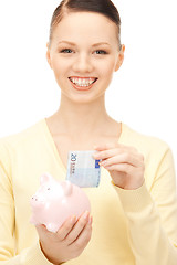 Image showing lovely woman with piggy bank 