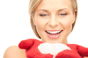 Image showing beautiful woman in red mittens with snow