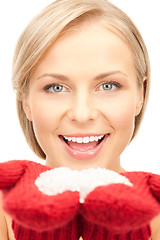 Image showing beautiful woman in red mittens with snow