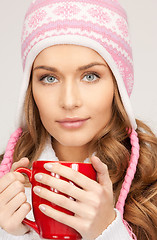 Image showing beautiful woman with red mug