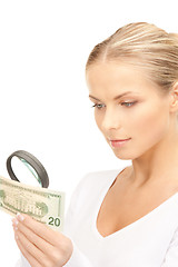 Image showing woman with magnifying glass and money