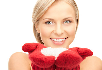 Image showing beautiful woman in red mittens with snow