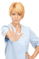 Image showing attractive female doctor showing stop gesture