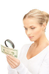 Image showing woman with magnifying glass and money