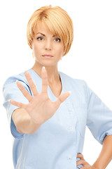 Image showing attractive female doctor showing stop gesture