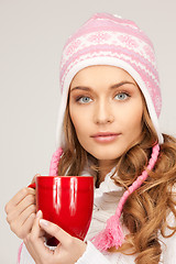 Image showing beautiful woman with red mug