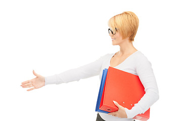 Image showing businesswoman with folders ready for handshake