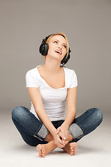 Image showing  happy teenage girl in big headphones