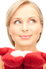 Image showing beautiful woman in red mittens with snow