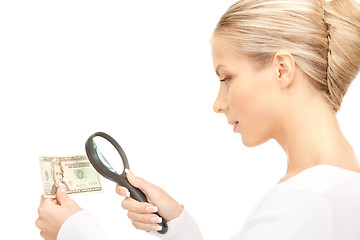 Image showing woman with magnifying glass and money