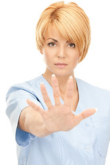 Image showing attractive female doctor showing stop gesture