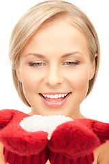 Image showing beautiful woman in red mittens with snow