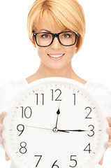 Image showing woman holding big clock