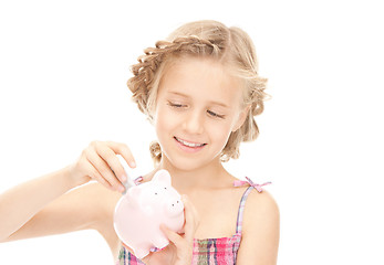 Image showing little girl with piggy bank and money