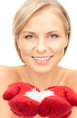 Image showing beautiful woman in red mittens with snow