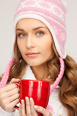 Image showing beautiful woman with red mug