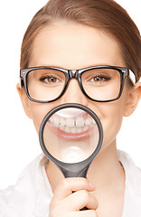 Image showing woman with magnifying glass showing teeth