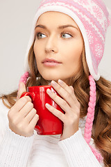 Image showing beautiful woman with red mug