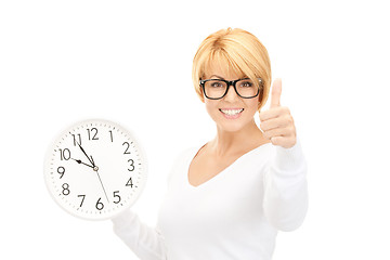 Image showing woman holding big clock