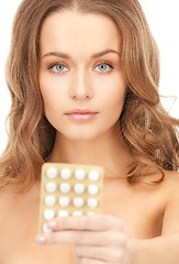 Image showing young beautiful woman with pills