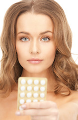 Image showing young beautiful woman with pills 