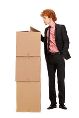 Image showing attractive businessman with big boxes