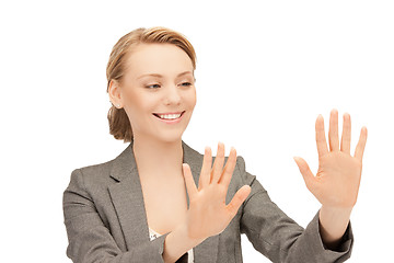 Image showing businesswoman working with something imaginary