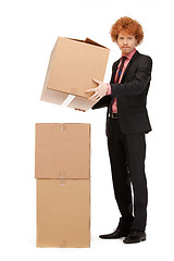 Image showing attractive businessman with big boxes