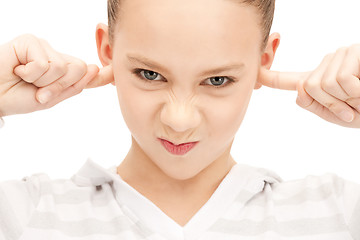 Image showing teenage girl with fingers in ears