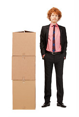 Image showing attractive businessman with big boxes