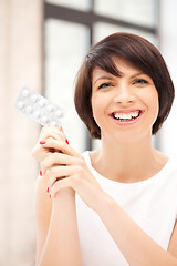 Image showing young beautiful woman with pills