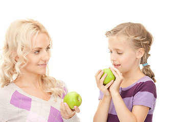 Image showing mother and little girl with green apple