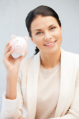 Image showing lovely woman with piggy bank