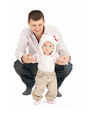 Image showing baby making first steps with father help